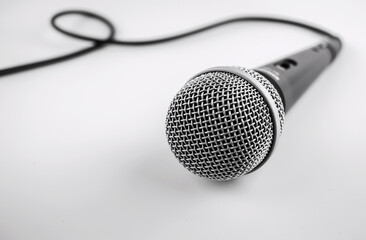 Microphone with a wire isolated on white background. Silver  microphone for studio.