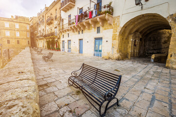 Fototapeta na wymiar Senglea, Malta - Metal bench at the city of Senglea on a sunny summer afternoon