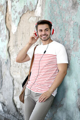 Handsome man with headphones listening music on street