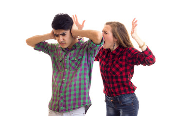 Young couple in plaid shirts arguing 