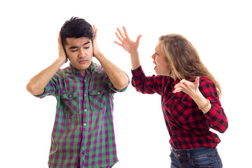 Young couple in plaid shirts arguing 