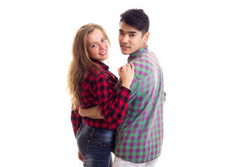 Young couple in plaid shirts hugging