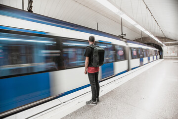 Man at the subway station with a backpack