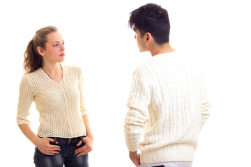 Young couple in white sweaters talking