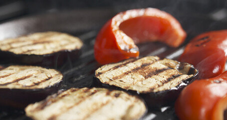 cooking eggplant and pepper on grill pan, wide photo