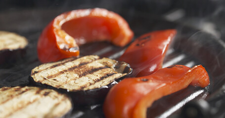 cooking eggplant and pepper on grill pan, wide photo