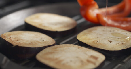 cooking eggplant and pepper on grill pan, wide photo