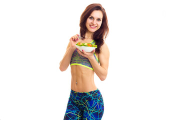 Sportive woman holding salad 