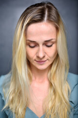 Portrait of a girl blonde, closeup, looking down