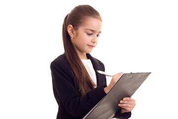 Little girl in black jacket holding pen and folder 