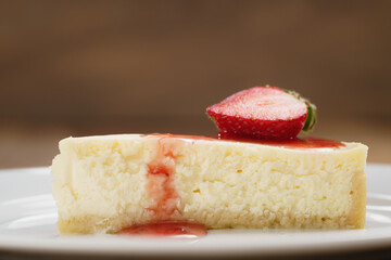 cheesecake with strawberry on plate closeup, shallow focus