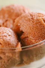 orange sorbet ice cream in glass bowl, shallow focus