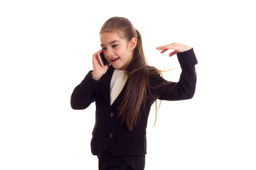 Little girl in black jacket talking on phone 