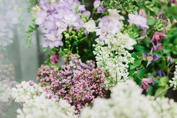 Obraz premium Bunches of white and purple lilac between green petals