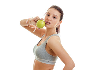 young cute girl holding a Green Apple and looks into the camera close-up