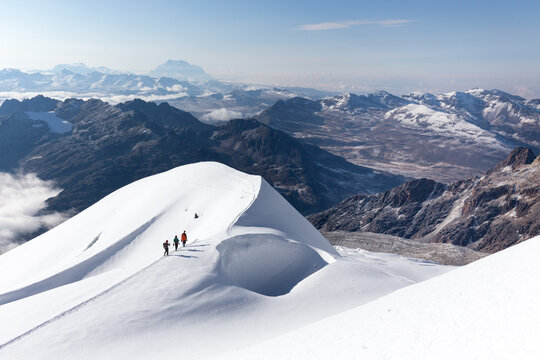 Mountaineers walking climbing snow trail mountains ridge, Bolivia.