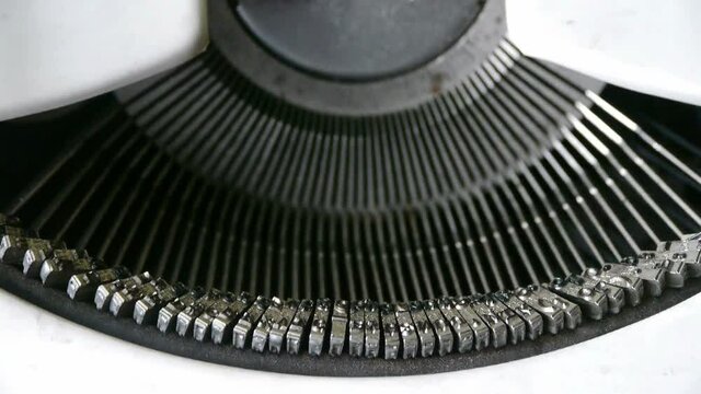 Hands typing on a typewriter.