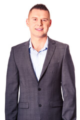 Happy young businessman looking at camera