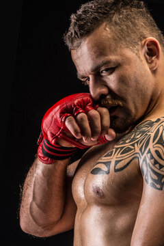 Muscular fighter posing with boxing gloves