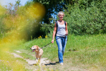 mature woman hiking with a dog