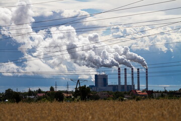 Fototapeta na wymiar White smoke coming out from factory chimneys