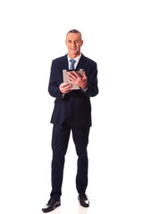 Full length mature man using digital tablet