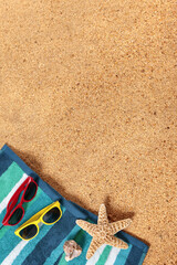 Tropical carribean beach background lower border with sunbathing towel sunglasses and starfish on sand summer couple holiday vacation scene design photo