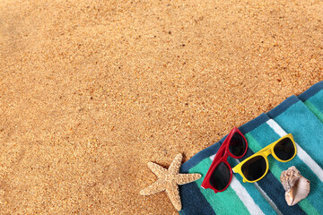 Tropical carribean beach background lower border with sunbathing towel sunglasses and starfish on sand summer couple holiday vacation scene design photo