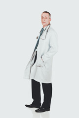 Male doctor with hands in pockets