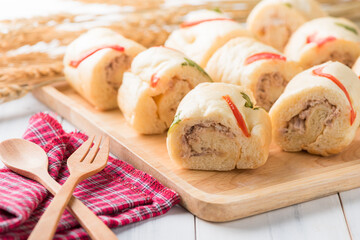 tuna in roll soft bread on white wood background