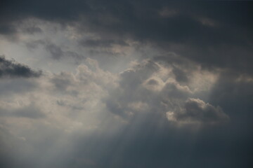 Sun through coming storm clouds