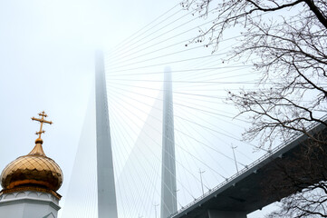 The dome of church near bridge in fog