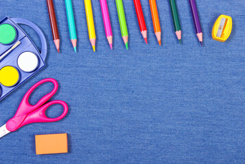 School and office supplies on jeans background, copy space for text