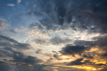 Naklejka na ściany i meble Sunset with partly cloudy sky. Dramatic sky