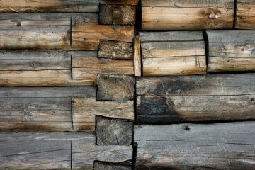 gray brown old log wall, background with wood texture