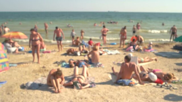 Blurred sea beach and people. Blurry seashore, daytime.