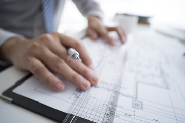 Men draw drawings using rulers