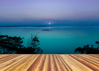 Perspective wooden empty with colorful seascape against purple sky.