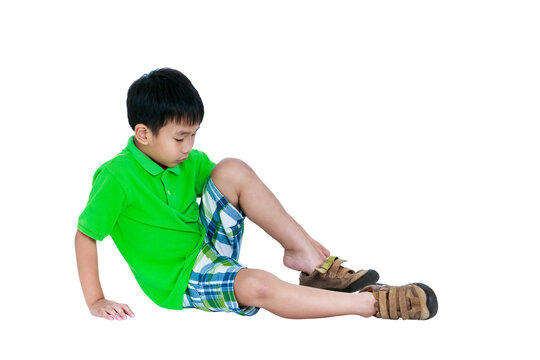 Side View Of Asian Child Put Leather Shoes On. Isolated On White Background.