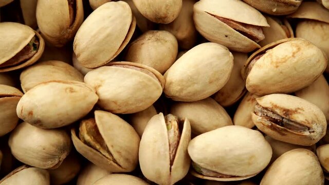 Food background. Roasted pistachio nuts seed with shell close up. Dieting concept. Dolly slider shot 4K ProRes HQ codec