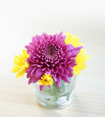 Purple and yellow flower decoration on wood table interior design background with copy space for text