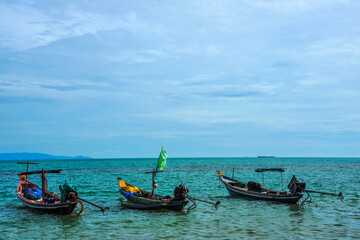 Fototapeta na wymiar Three fishing boats floating on sea
