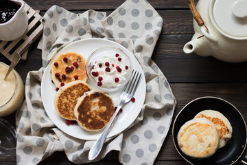 Cheesecakes for breakfast on a dark wooden background