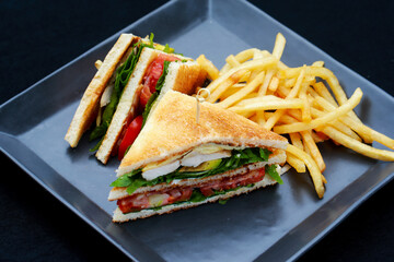 Club sandwiches with french fries on side