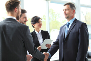 Business people shaking hands, finishing up a meeting.