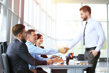 Business people shaking hands, finishing up a meeting.