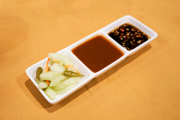 Pickles cucumber, tauco, ketchup, and spicy soy sauce for condiment in table restaurant