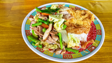 fried mix vegetable with pork and omelet on rice