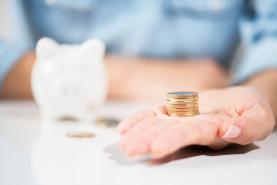 Woman holding Coins .Showing Save Money Concept