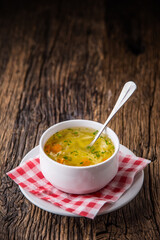 Chicken broth.Beef Broth. Bone broth with noodles carrot and parsley in white bowl.